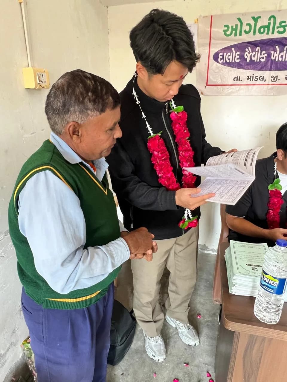 Client reviewing records with a member of an organic farming group