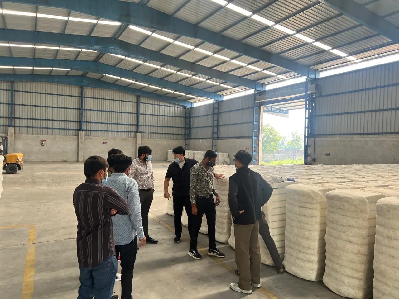 Clients and our team inspecting stacked cotton bales