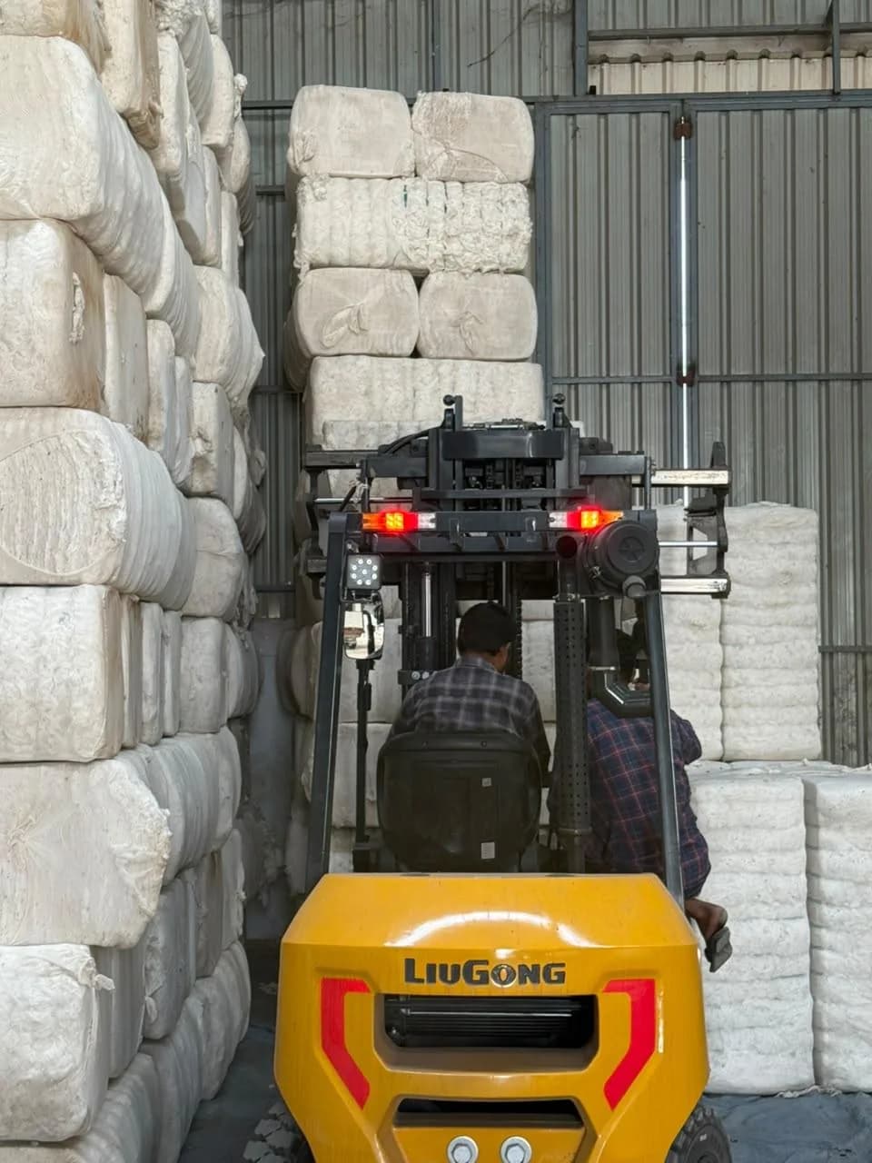 Forklift moving cotton bales in the warehouse