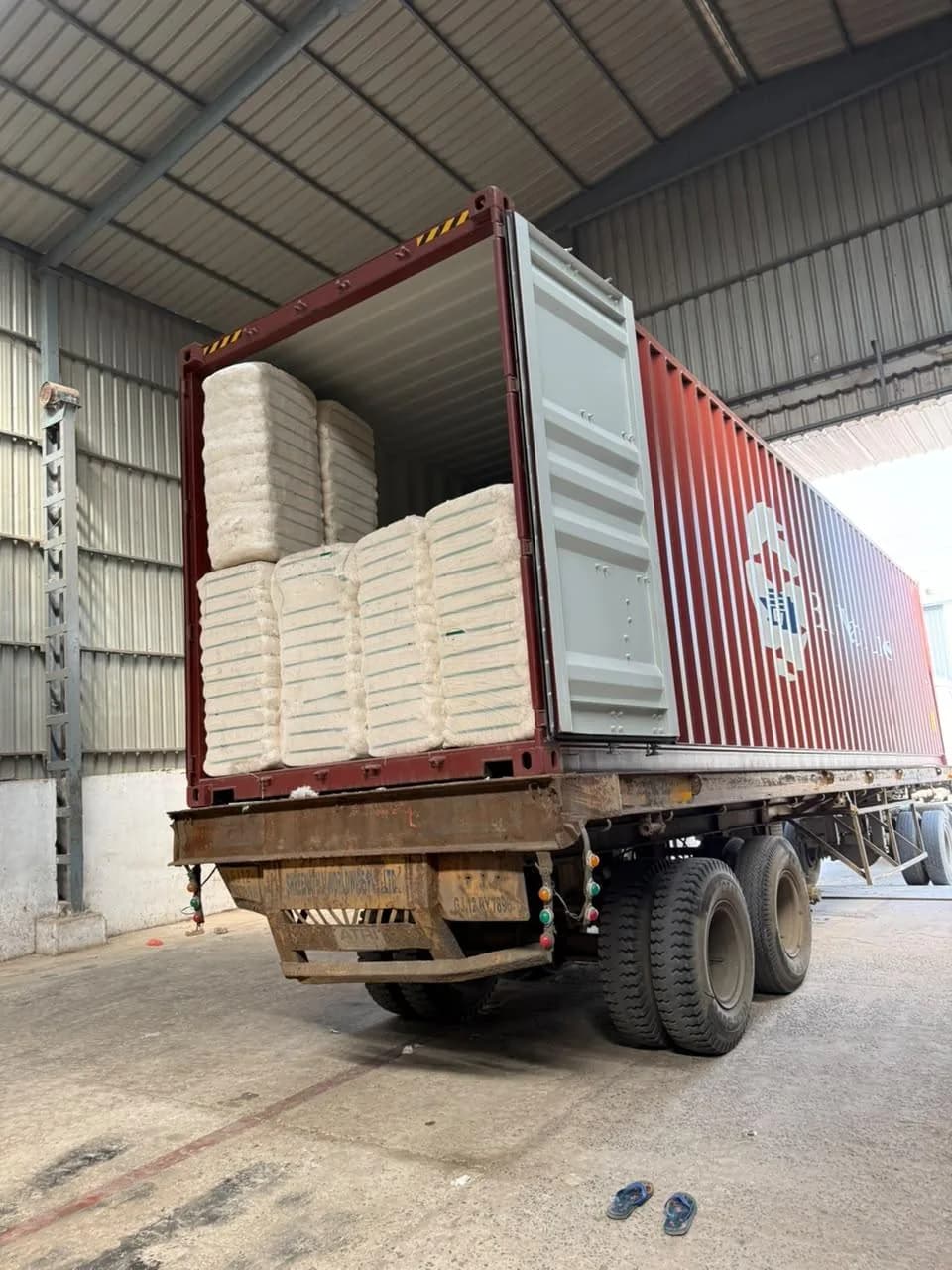 Cotton bales being loaded into a shipping container